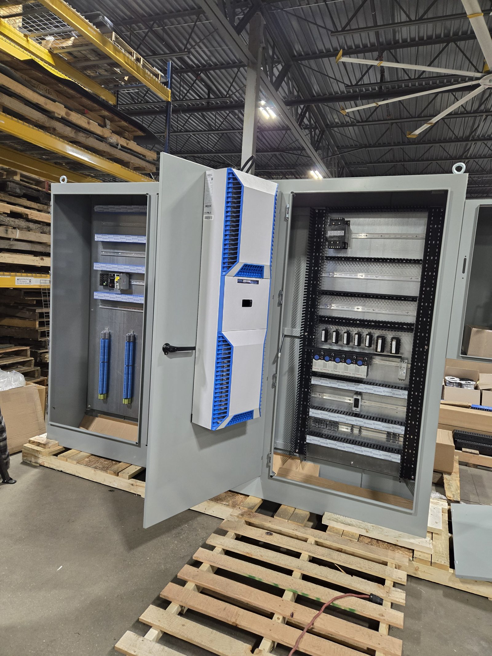 Control enclosure with the door open and back panel mounted