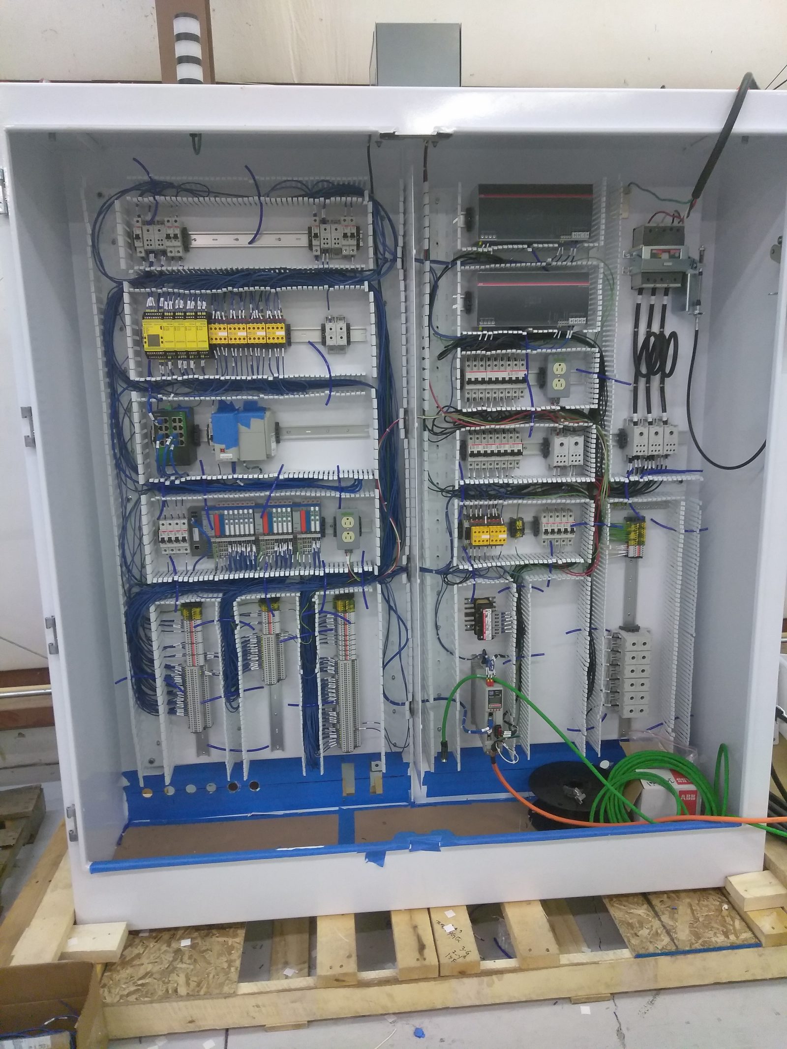 Large back panel with drives, I/O, and blue field wiring
