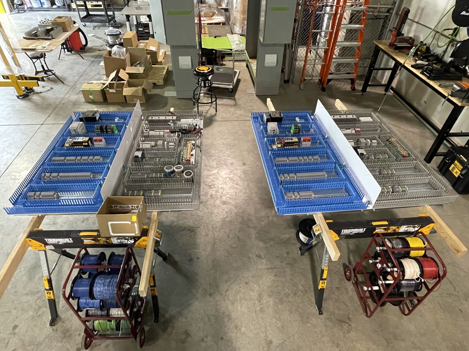 Panel assemblies laid out on shop tables during a build