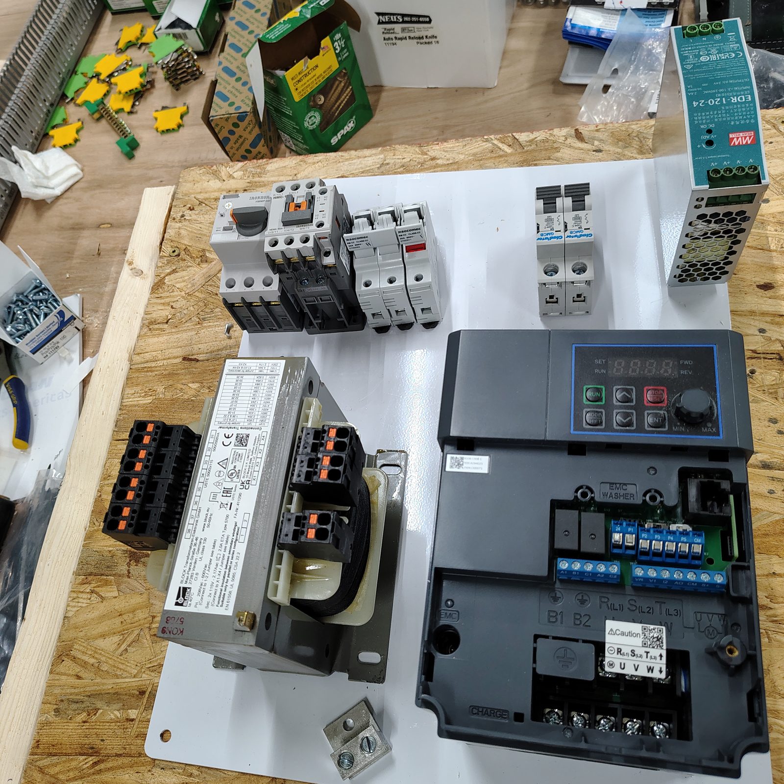 Control components staged on the bench before panel assembly
