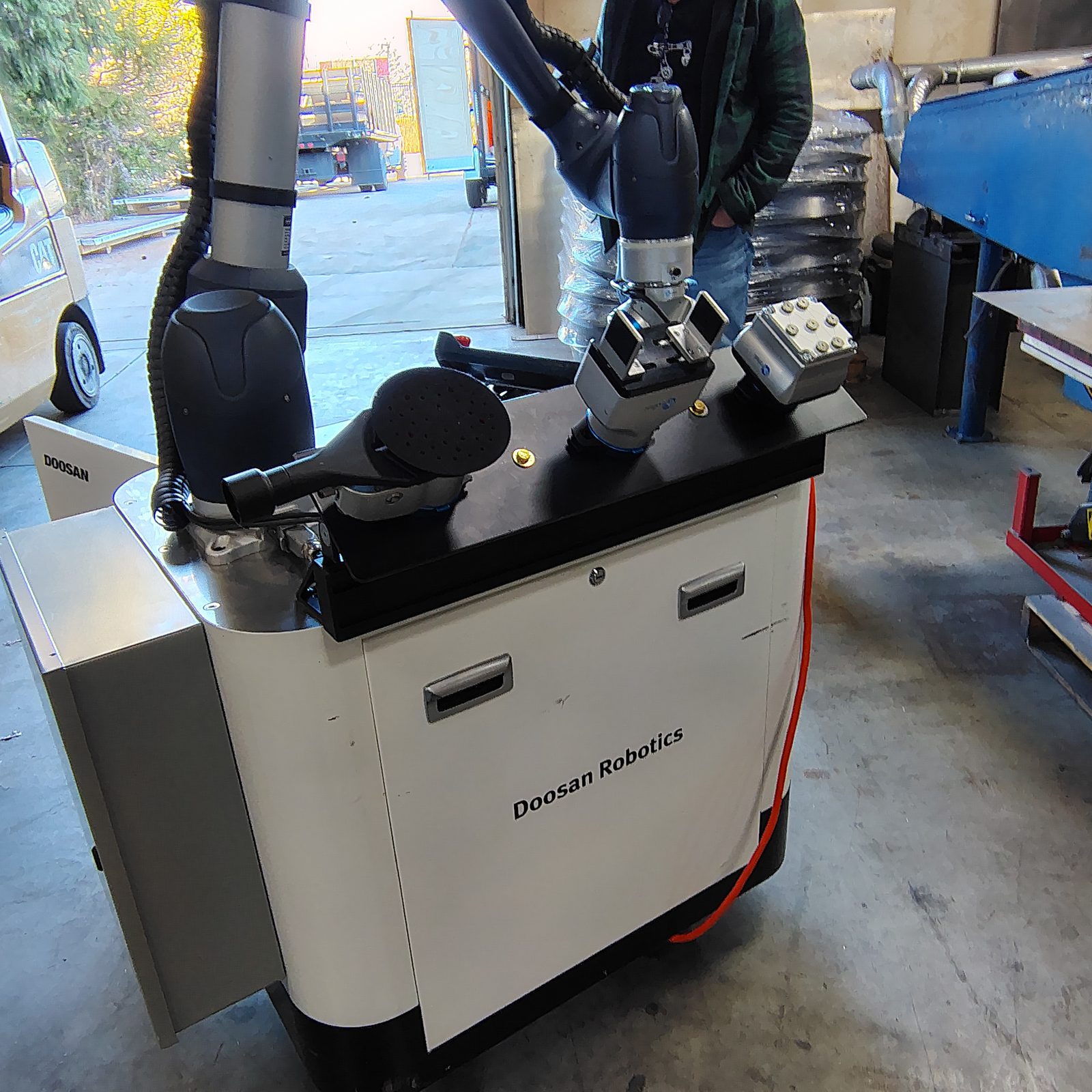 Doosan collaborative robot on a mobile cart with end-of-arm tooling