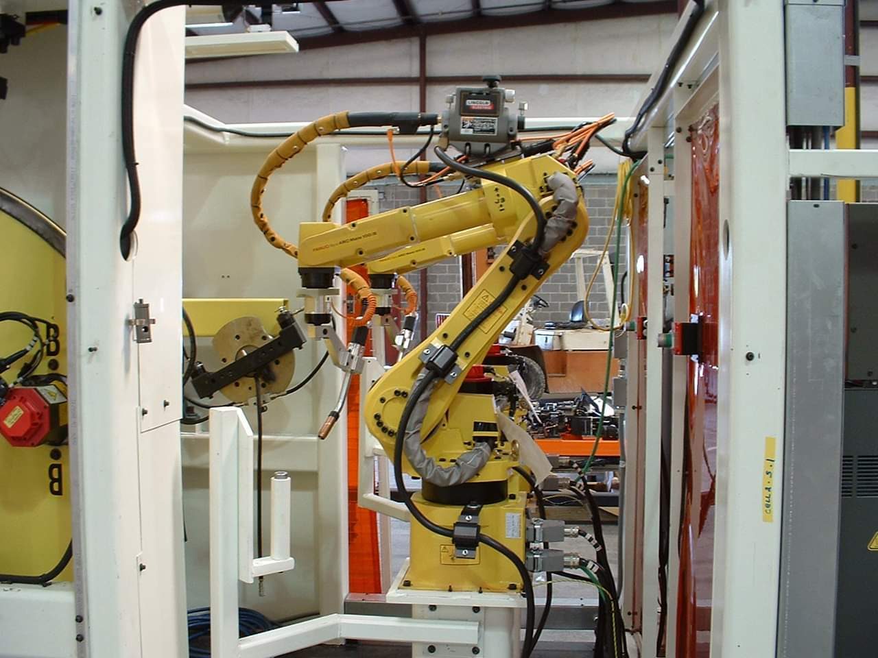 Robot welding cell inside a guarded automotive work cell