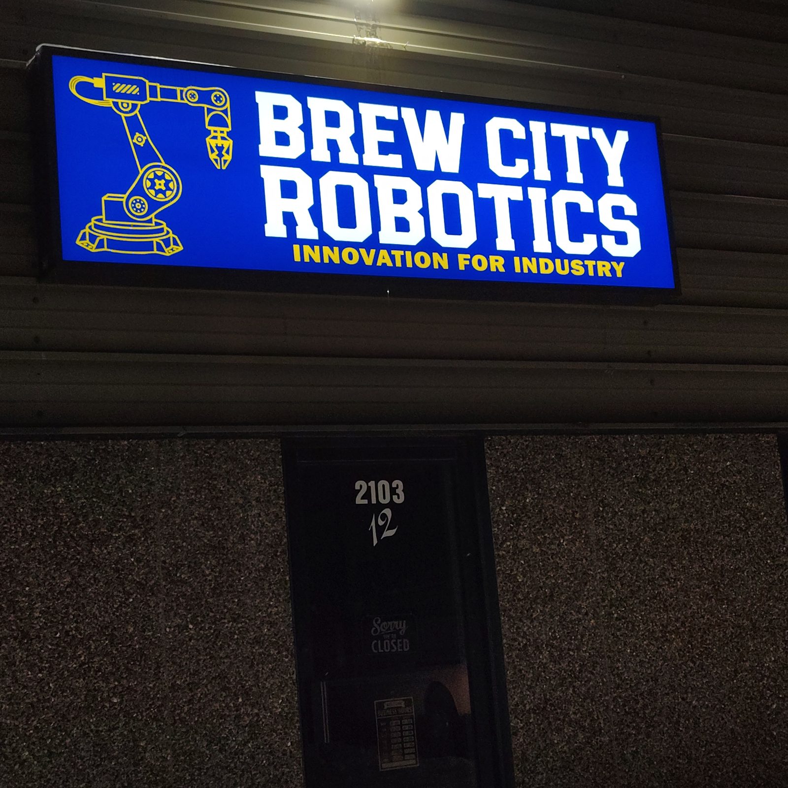 The Brew City Robotics sign lit at the shop entrance